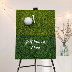 Golf ball and tee on green grass foam board