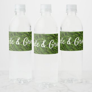 Golf ball and tee on green grass with love wedding water bottle label
