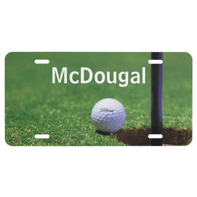 Golf ball at edge of cup Close-up photo License Plate (Front)