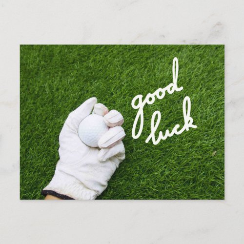 Golf ball in hand with GOOD LUCK word on green Postcard