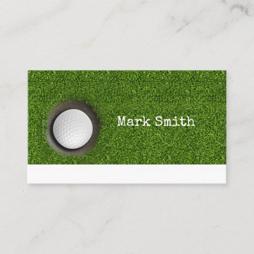 Golf ball is in the hole on green with name  business card