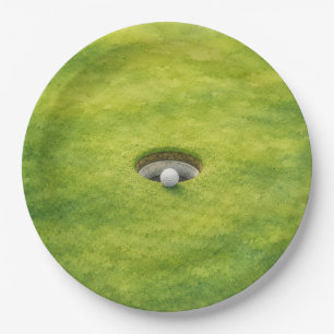 Golf ball is next to the hole on putting green paper plates