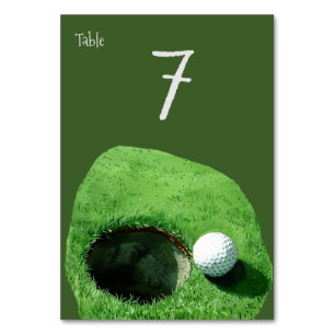Golf ball next to the hole for Golfer Party  Table Number
