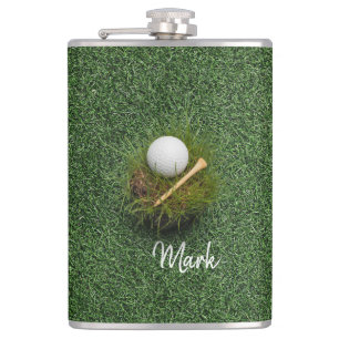 Golf ball on green grass flask