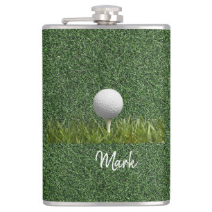 Golf ball on green grass flask