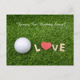 Golf ball on green grass for golfer birthday postcard