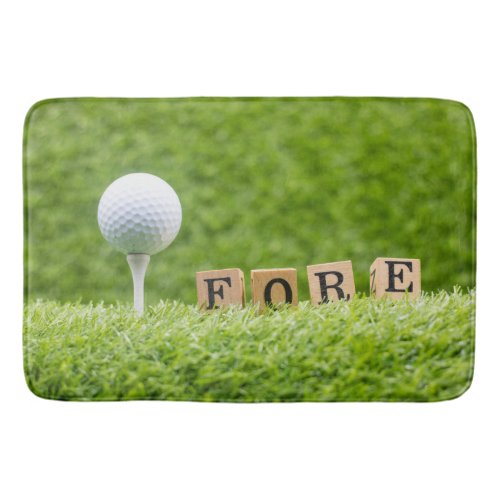 Golf ball on green grass with FORE Bath Mat