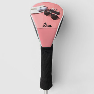 Golf ball  tee and sunglasses on pink pastel head cover