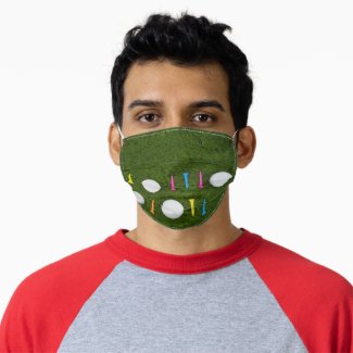 Golf ball with colorful tee on green grass adult cloth face mask