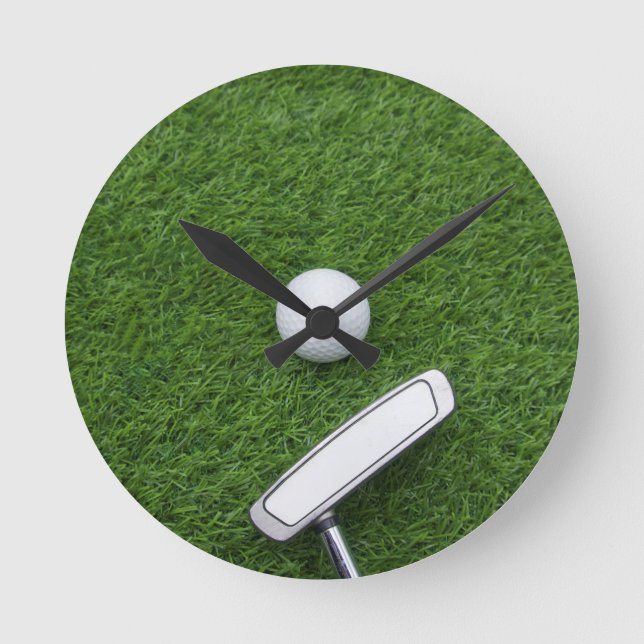 Golf ball with putter are on green grass round clock (Front)