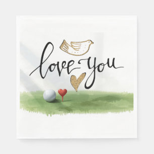 Golf ball with red heart tee on green grass napkins