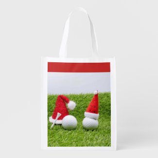 Golf ball with Santa Hat are on green grass Grocery Bag