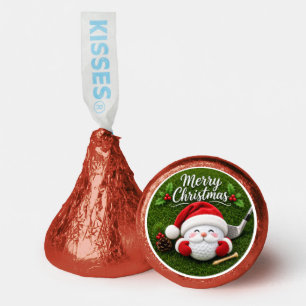Golf ball with Santa hat on green grass Hershey®'s Kisses®