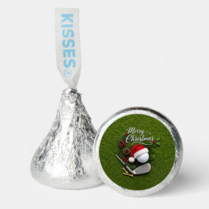 Golf ball with Santa hat on green grass Hershey®'s Kisses®