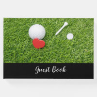 Golf ball with tee and red heart on green wedding guest book