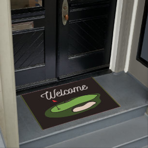 Golf ball with tee on green grass doormat