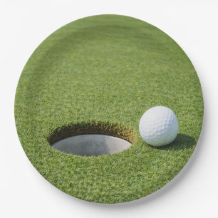 Golf ball with tee on green grass golfer party paper plates