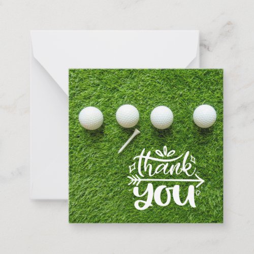 Golf ball with thank you so much on green grass note card