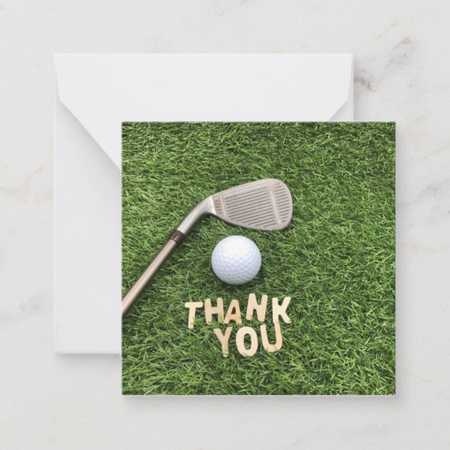 Golf ball with thank you word on green grass  note card (Front)