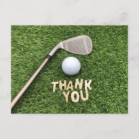 Golf ball with thank you word on green grass postcard