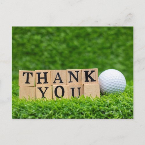 Golf ball with thank you word on green grass  postcard