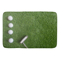 Golf balls are on green grass bath mat