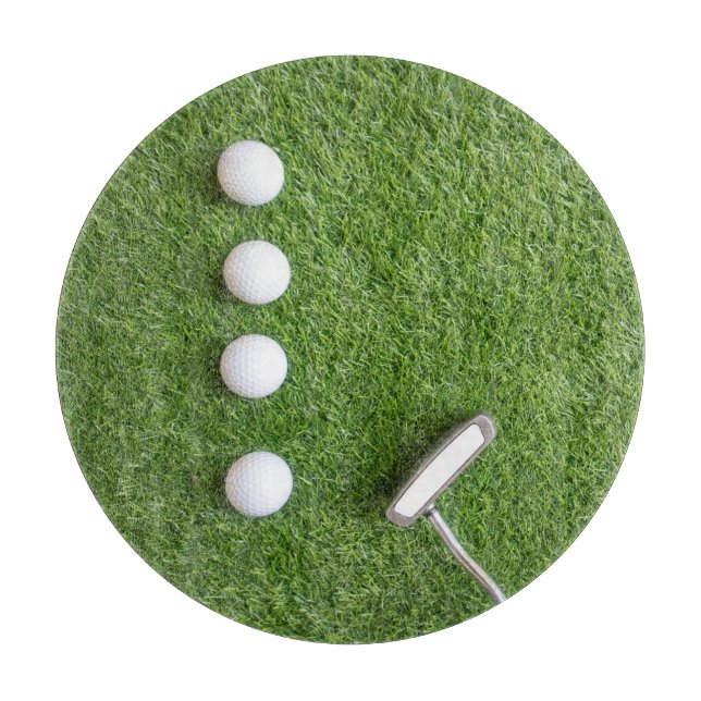 Golf balls are on green grass cutting board (Front)