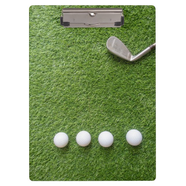 Golf balls are on green grass notebook clipboard (Front)