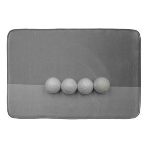 Golf balls on grey background bath mat