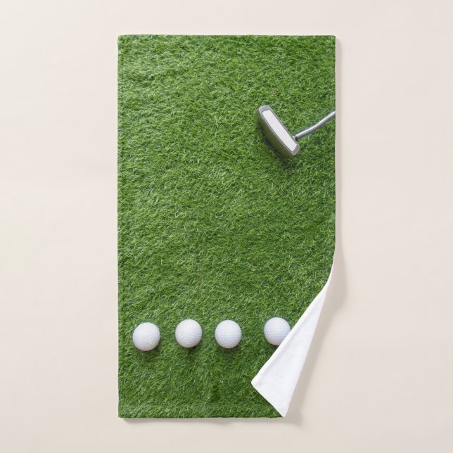Golf balls with Putter are on green grass  Hand Towel (Hand Towel)