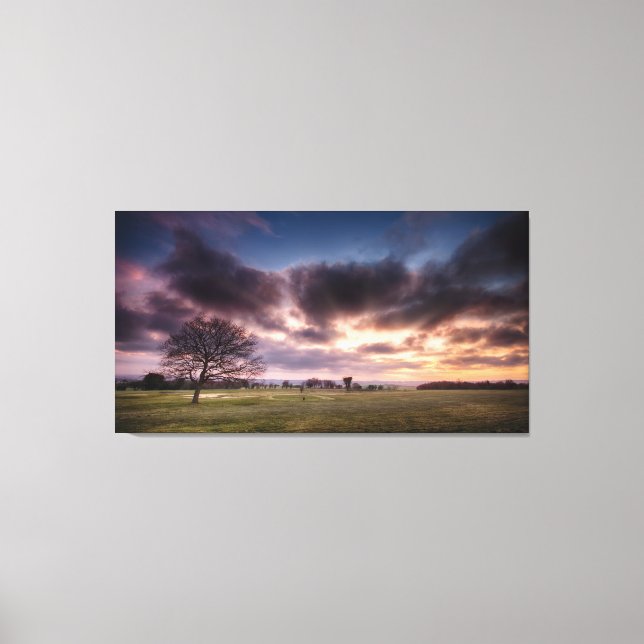 Golf course landscape with a red sunset sky canvas print (Front)