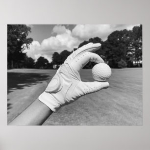 Golf Glove Holding Ball on Fairway Poster