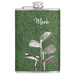 Golf iron on green grass flask