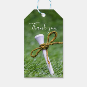 Golf tee with ribbon on green grass thank you gift tags