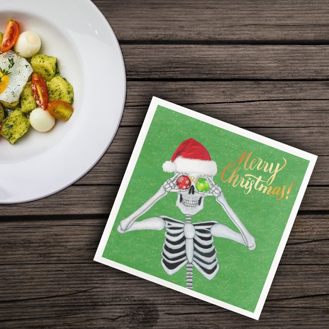 Goofy Christmas Skeleton Ornament Eyes Hat Green Paper Dinner Napkins (Fun skeleton holding ornaments to eyes on green Merry Christmas paper party napkins)