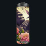 Gorilla in a Fantasy Garden Thermal Tumbler<br><div class="desc">This whimsical illustration features a pensive gorilla sitting among a lush array of vibrant pink and yellow flowers in a magical garden. A hummingbird hovers nearby,  and a small swing hangs from a tree branch. The scene is filled with a soft,  warm light and has a peaceful,  enchanted atmosphere.</div>