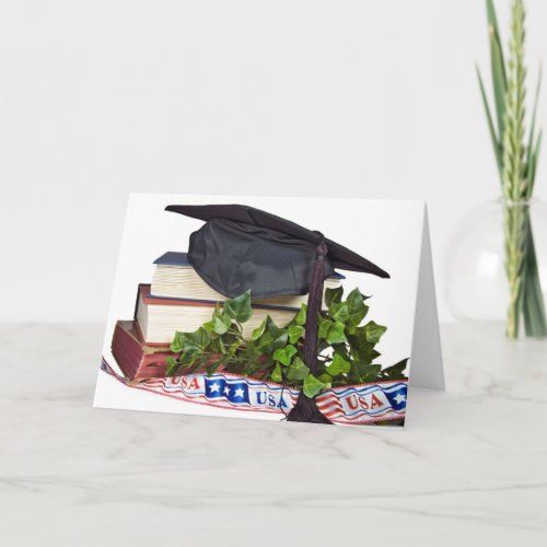 Graduation cap on books with patriotic ribbon card