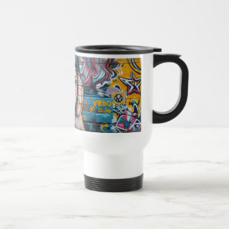 Graffiti on a wall of a woman travel mug