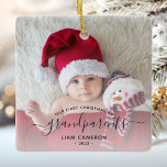 Grandparents First Christmas Photo Black Script Ceramic Ornament<br><div class="desc">Help them celebrate their first grandchild with this beautiful modern keepsake ornament. The off-black text reads "Our first Christmas as grandparents, " with the word "grandparents" in elegant handwriting script with flourishes before and after. Easily replace the sample image with your favorite photo of the new baby, and add his...</div>