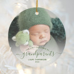 Grandparents First Christmas Photo Green Script Ceramic Ornament<br><div class="desc">Help them celebrate their first grandchild with this beautiful modern keepsake ornament. The green text reads "Our first Christmas as grandparents, " with the word "grandparents" in elegant handwriting script with flourishes before and after. Easily replace the sample image with your favorite photo of the new baby, and add his...</div>