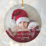 Grandparents First Christmas Photo White Script Ceramic Ornament<br><div class="desc">Help them celebrate their first grandchild with this beautiful modern keepsake ornament. The white text reads "Our first Christmas as grandparents, " with the word "grandparents" in elegant handwriting script with flourishes before and after. Easily replace the sample image with your favorite photo of the new baby, and add his...</div>