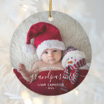 Grandparents First Christmas Photo White Script Ceramic Ornament<br><div class="desc">Help them celebrate their first grandchild with this beautiful modern keepsake ornament. The white text reads "Our first Christmas as grandparents, " with the word "grandparents" in elegant handwriting script with flourishes before and after. Easily replace the sample image with your favorite photo of the new baby, and add his...</div>