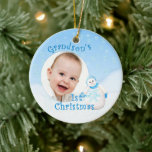 Grandson's 1st Christmas Snowman Ceramic Ornament<br><div class="desc">Your grandson will cherish his 1st christmas snowman ornament with his photo. This adorable showman is decked out in fuzzy blue hat, scarf and mittens as delicate snowflakes fall through the winter sky. Add photo to front and name and year to the back of the ornament using the template provided....</div>