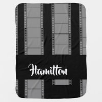 Gray camera film on black baby blanket