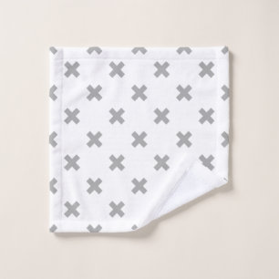 Gray cross stitches on white wash cloth