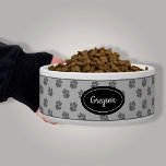 Gray Dog Paws Pattern With Custom Name Bowl<br><div class="desc">Gray dog paw print pattern background with a black badge that has a personalizable text area for the name of the pet. The font is a lovely script font in white color.</div>