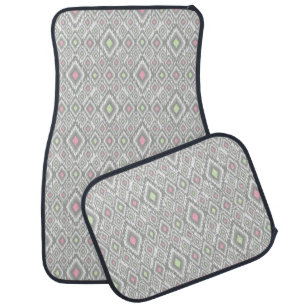 Gray, green, pink rhombuses on a white car floor mat