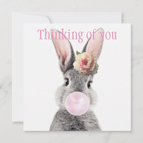 Gray rabbit blowing bubble gum with anemone flower