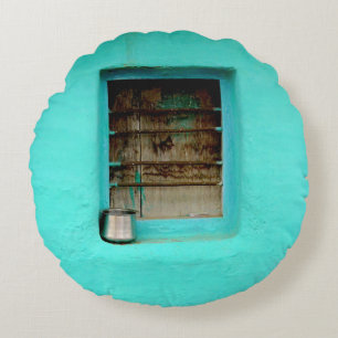 GRAY STEEL CONTAINER ON WINDOW WITH TEAL PAINT ROUND PILLOW