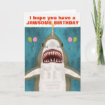 Great White Shark Funny Jawsome Birthday Pun Humor Card<br><div class="desc">The Great White Shark on this funny greeting card is so kind. See? It's smiling and hoping you have a jawsome birthday. It even brought balloons and is balancing a candle on its nose. The design includes a hand-drawn shark on a blue / sea green background with the silhouettes of...</div>
